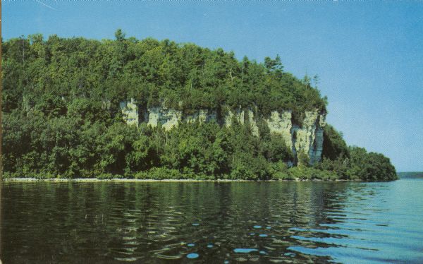 View across water towards the 180-foot high Eagle Bluff. The bluff received its name from the eagles which formerly nested there.