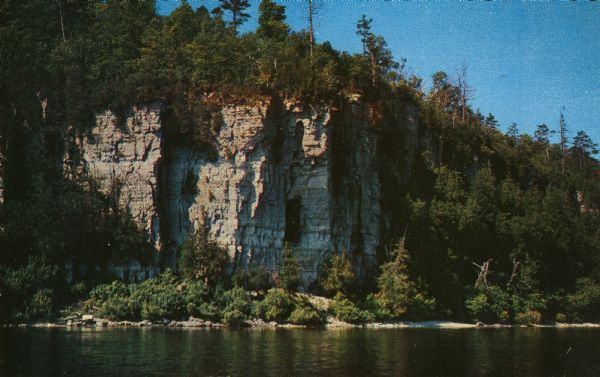 View across water towards the 180-foot high Eagle Bluff. The bluff received its name from the eagles which formerly nested there.