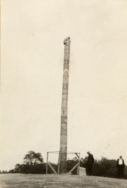 A totem pole erected in 1927 in honor of the aboriginal inhabitants of Wisconsin. Potawatomi chief Simon Onanguisse Kahquados (1851-November 27, 1930), an historian and advocate of his tribe, was interred beneath a nine-ton boulder on the site on Memorial Day, 1931.