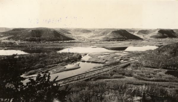 Elevated view of Perrot State Park (Trempealeau vicinity) looking west from Brady's Bluff toward the Mississippi River and Minnesota. Railroad tracks run along the water in the foreground.