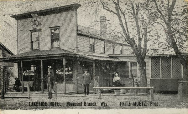 A view of the Lakeside Hotel, showing the saloon and restaurant. People are posing in front. Caption reads: "Lakeside Hotel, Pheasant Branch, Wis. Fritz Muetz, Prop."
