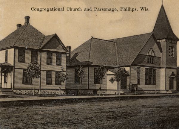 View across road towards the church. Caption reads: "Congregational Church and Parsonage, Phillips, Wis."