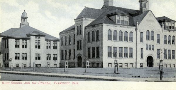 A view of the High School and Grade School. Caption reads: "FHigh School and the Grades, Plymouth, Wis."