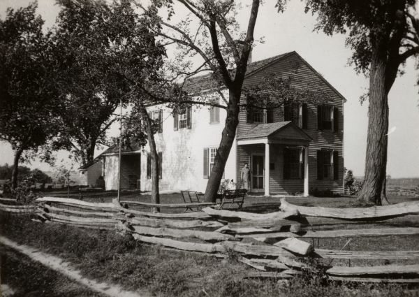 A view of the Indian Agency house after restoration. A person is standing on the porch.
