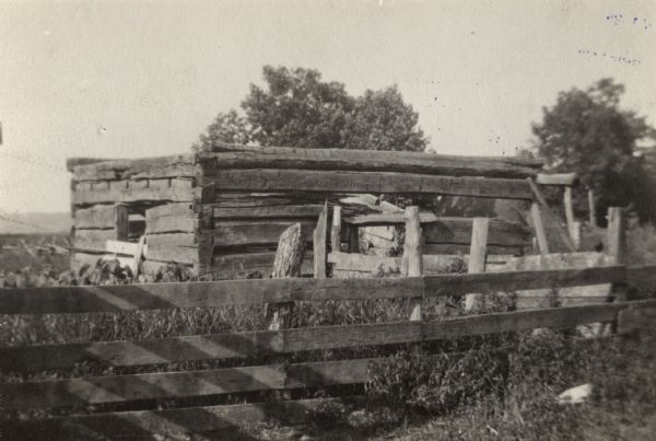 The Coumbe homestead, home of John Coumbe, the first white settler in Richland County, who came to the site in 1838. The original buildings were log structures which were burned, except for the remains shown in this print.