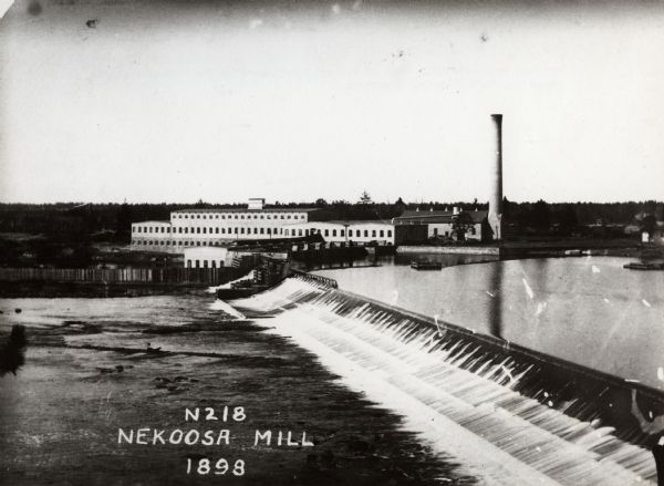 A view of the Nekoosa-Edwards Paper Company mill. Established about 1896 by John Edwards. Caption reads: "Nekoosa Mill".