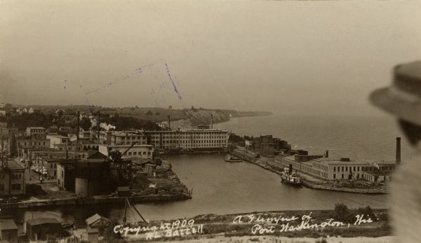 Elevated view of town. A person is in the right foreground. Caption reads: "A Glimpse(?) of Port Washington, Wis."