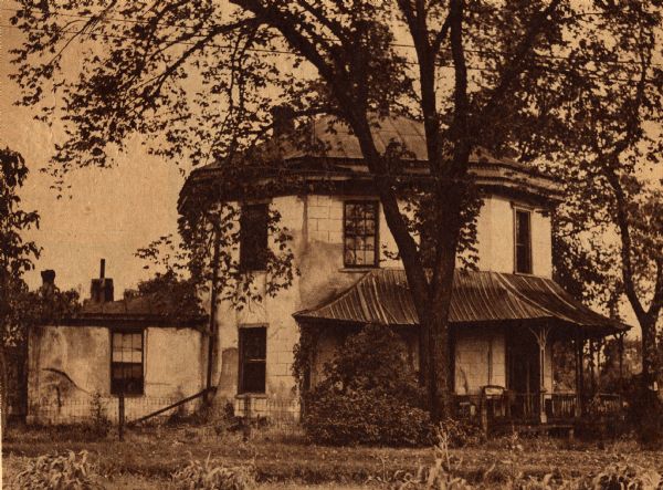 The Benedict House. Built by Dr. Alonzo Benedict and designed for two families. The original roof did not function correctly, so the builder put on a second roof, being careful to repeat the dentil motif on the cornice.