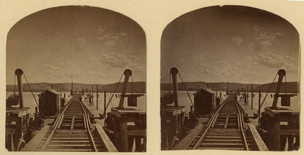 Stereograph of John Lawler's pile-pontoon railway bridge over both channels of the Mississippi River at Prairie du Chien, and McGregor, Iowa. East draw, 396 feet in length looking west.
