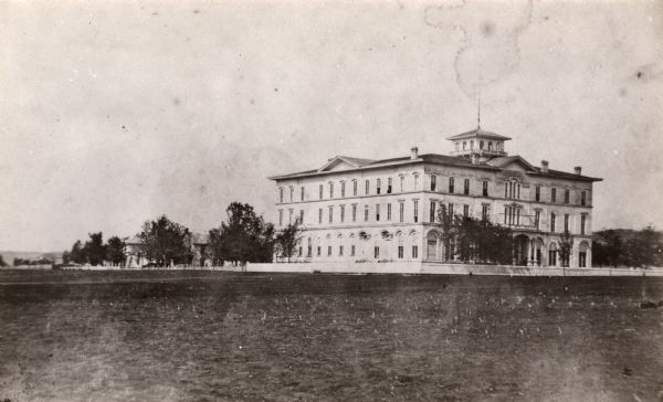 View across open grounds towards the Brisbois Hotel, built in the early 1860's, and used as a hospital during the Civil War. It was later part of Campion High School.
