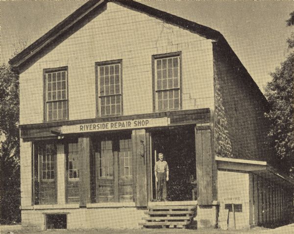 Former building of the Astor Company, also known as the Brisbois Fur Trading Post. The American Fur Company, which had been organized by John Jacob Astor in 1808, first began operations in Prairie du Chien in 1817. At the time this photograph was taken, the structure was occupied by Ben Schaub's Riverside Repair Shop.