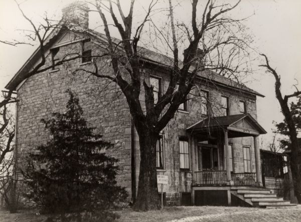 The northwest facade of the Michael Brisbois house, built in 1815. A sign near the entrance reads: "Brisbois Residence".