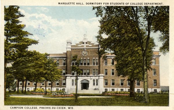 View across grounds towards Marquette Hall. Caption at top reads: "Marquette Hall, Dormitory for Students of College Department." Caption at bottom reads: "Campion College, Prairie-Du-Chien, Wis."