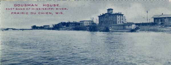 The Dousman House as seen from the Mississippi River. Caption reads: "Dousman House, East Bank of Mississippi River, Prairie Du Chien, Wis."
