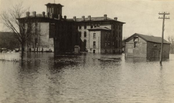 Dousman House hotel, surrounded by Mississippi River flood water in spring. View looking northwest.