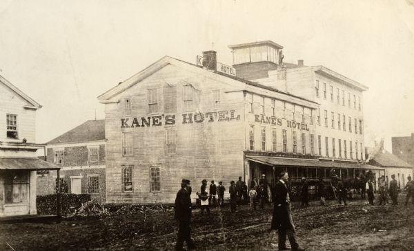 Kane's Hotel, built in about 1839 by Ezekiel Tainter, and then called the Phoenix Hotel, on Main Street. It passed through many hands but retained the original name until Alonzo Kane bought it (date unrecorded in available sources). He sold it in 1861 to J. George Schweizer who held it until it was destroyed in a large fire on Nov. 8, 1873. If Schweizer changed its name, this photograph would date to before 1861, but no such change was mentioned in county histories.