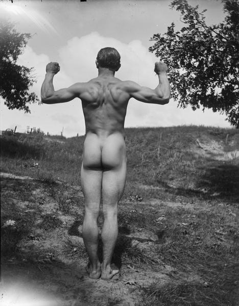 Male nude flexing back muscles, identified as probably Lutie Frantz.