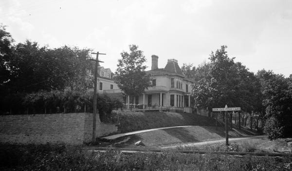 This house was the Madison home of Robert M. La Follette, Sr., and Belle Case La Follette from the time of their marriage until they moved to the Governor's Mansion on Gilman Street in 1901.  It is photographed here from across the Chicago, Milwaukee and St. Paul tracks, looking toward the back and side of the house.  The house actually fronted on Wilson Street and the La Follettes' property extended back to Lake Monona.  After the La Follettes moved, the property was subdivided into several small lots and the address of the original house, which is a Madison historic landmark, is now 314 S. Broom Street.  La Follette's sister Josephine and her husband Judge Robert Siebecker lived in the house next door.