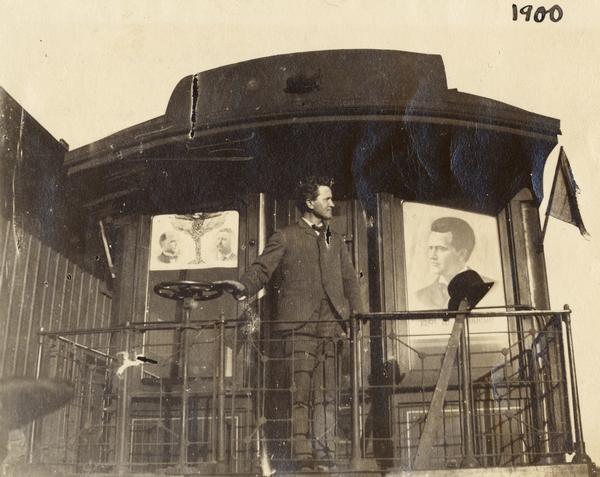 Robert M. La Follette, Sr., on the back of his campaign train which is decorated with a poster for William McKinley and Theodore Roosevelt national ticket, as well as his own candidacy for governor of Wisconsin.