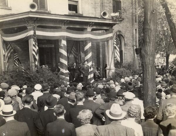 View over crowd towards Senator Robert M. La Follette, Jr., speaking to a Progressive Party rally at Mauston, Wisconsin. Bob, Jr., became senator after the death of his father, Robert M. La Follette, Sr., in 1925.