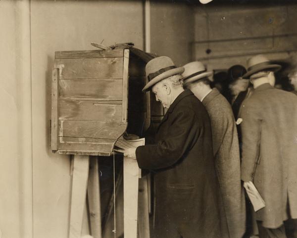 View of Robert M. La Follette, Sr., at the voting booth in Maple Bluff, Wisconsin at the conclusion of his independent, third-party Presidential campaign.