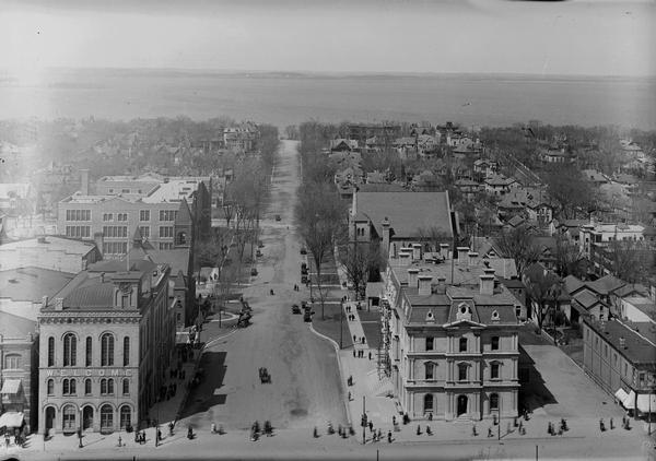 Wisconsin Avenue looking toward the northwest from the top of the Capitol. The elevated perspective provides an unusual view of the old City Hall (left) and Post Office (right), and the street beyond, a view possible thanks to the construction of the new Capitol dome.