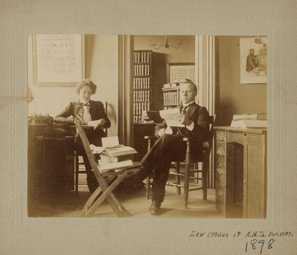 Attorney Albert G. Zimmerman in his Madison law office, dictating a letter to secretary Jennie Nelson.  Until 1894 Zimmerman was the law partner of Robert M. La Follette, Sr., in the firm Harper, Roe, La Follette, & Zimmerman.  The partnership dissolved to allow La Follette to pursue his political career.  At that time La Follette, Roe, and Zimmerman each moved to separate, but adjoining offices on the second floor of the Fairchild Block, 29 East Main Street.  Jennie Nelson, who identied herself as a general secretary in the 1900 city directory, probably worked for all three attorneys.  Albert Zimmerman later became a Dane County and Circuit Court judge.  Jennie Nelson became the secretary to Governor La Follette.