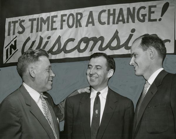Publicity photo at a pre-convention session of the Wisconsin State Democratic Party that includes William Proxmire and James E. Doyle, rival candidates for the party nomination. With them is Representative Lester Johnson, who had won an upset victory over a Republican during the previous year.