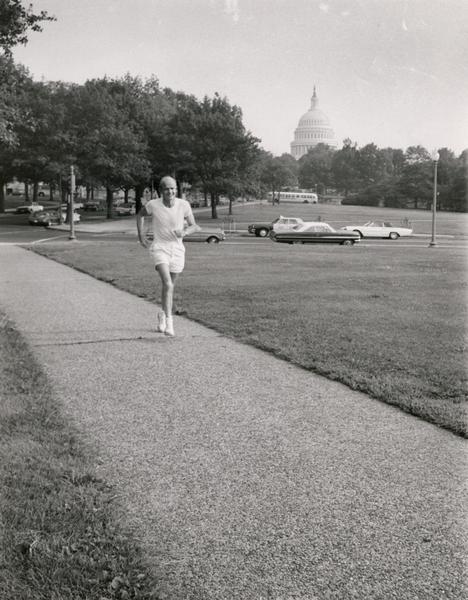 Senator William Proxmire jogging on the mall in front of the U.S. Capitol. Proxmire was a physical fitness advocate, and he was well known for his daily runs to and from Congress.
