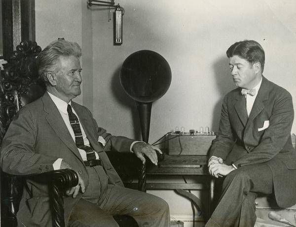 Robert M. La Follette, Sr., independent third-party Presidential candidate, and his son Robert M. La Follette, Jr., listen to a radio address by President Coolidge.  This news story is as much about the radio on the table between the two La Follettes, as it is about the campaign, noting that the candidate "intends to use the radio during the campaign, not only to broadcast some of his own speeches but to get a line on the utterances of his opponents."