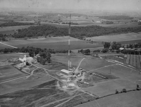 Aerial view of the new Madison television facility, WISC-TV (Channel 3), showing the transmitting tower in construction.  The location is to the southwest, several miles outside the Madison limits, in the area south of the Beltline Highway. (12-14), and west of Verona Road (Highways 18-151).