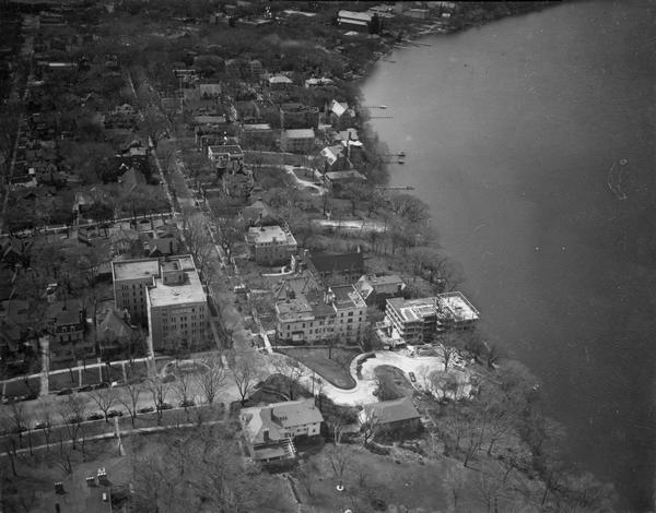 Aerial view of the Lake Mendota shoreline during the construction of the Edgewater Hotel.  It is a view looking west over the junction of Langdon Street and Wisconsin Avenue.