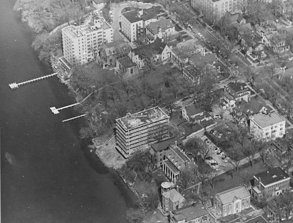 An air view looking east along the Lake Mendota shoreline.  The large building under construction at the center is Carroll Hall, a University of Wisconsin women's dormitory.