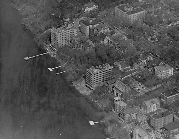 Aerial view looking east along Madison's Lake Mendota shoreline. The large building under construction at center is Carroll Hall, a University of Wisconsin women's dormitory.