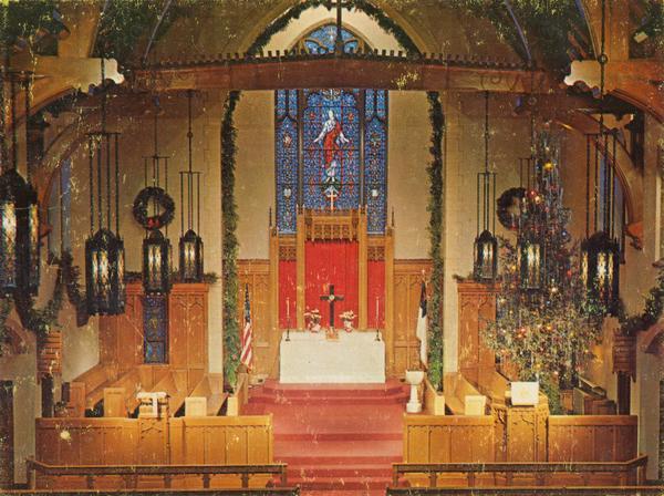 Elevated view of the interior of the front area in Bethel Lutheran Church, showing the altar and large stained glass window.