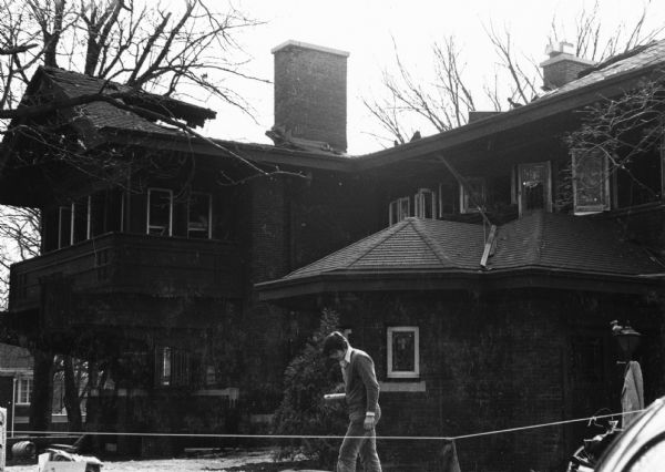 The Bradley House, later the Sigma Phi Fraternity house, after a fire on March 17. A young man is walking in front of the house.