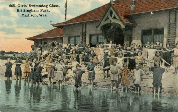 A colorized image of a girls' swimming class at the Brittingham Park bathhouse. Caption reads: "Girls' Swimming Class, Brittingham Park, Madison, Wis."