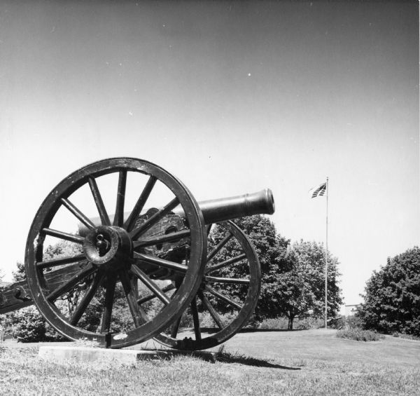 Camp Randall Memorial Park cannon with American flag flying in the background.