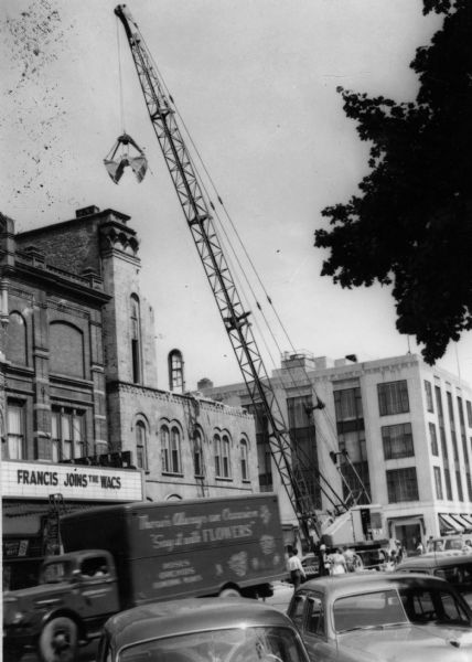 A crane is used in the demolition of City Hall on the corner of Mifflin Street and Wisconsin Avenue.