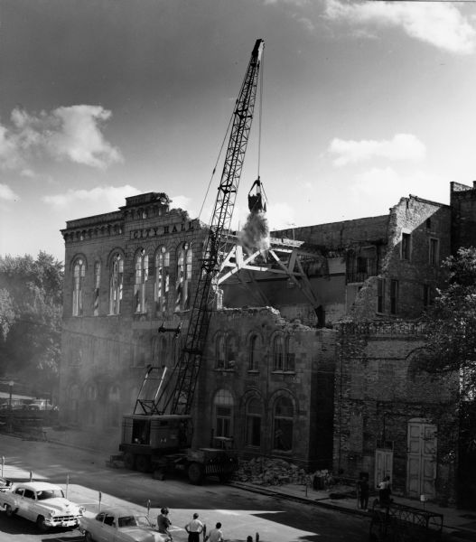 Old City Hall being razed with a crane and wrecking ball.