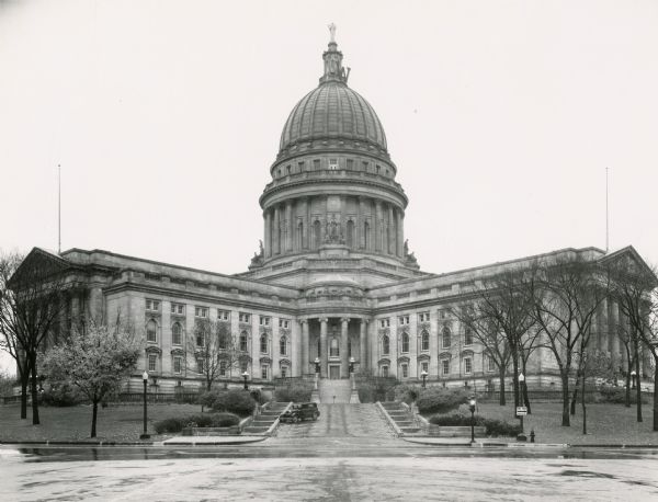 Exterior view of the Wisconsin State Capitol during a rain shower.