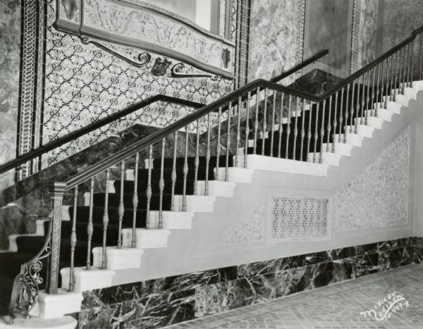 Capitol Theatre foyer with staircase and iron railing.