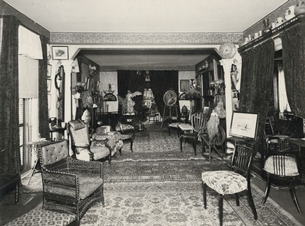 The parlor of the Lucius Fairchild residence at 302 Monona Avenue in Madison, filled with artwork and furniture collected by the Fairchilds during their residence abroad during the 1870s. Among the artworks that can be seen is a portrait of Sarah Fairchild Dean Conover, sister of Lucius Fairchild, painted by Eastman Johnson. This painting is now part of the collection of the Historical Society Museum, see Image #2590 or Museum #1942.2