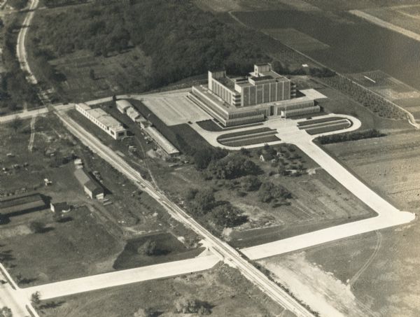 An aerial view of the Forest Products Laboratory. The view shows a newly completed railroad underpass and street approach.