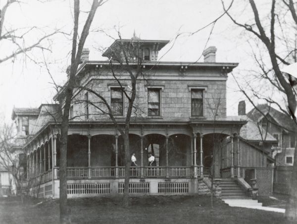 The Joseph William Hobbins House at 114 West Gilman. Two woman are standing on the front porch.