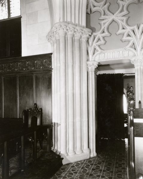 An interior view of the Grace Episcopal Church, showing a doorway between the altar rail and choir pews.