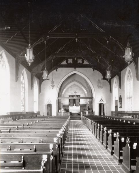 Interior view of the Grace Episcopal Church, looking down the main aisle from the back of the church.