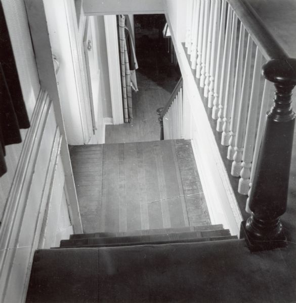 Interior view of the house at 524 North Henry Street, showing the first floor stairway down to the lower level.
