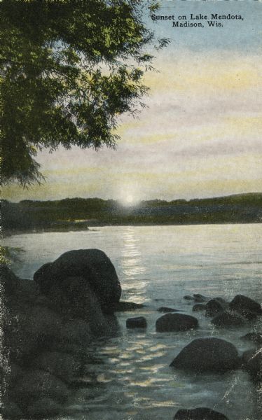 Sunset over Lake Mendota. A rocky shoreline is in the foreground. Caption reads: "Sunset on Lake Mendota, Madison, Wis."