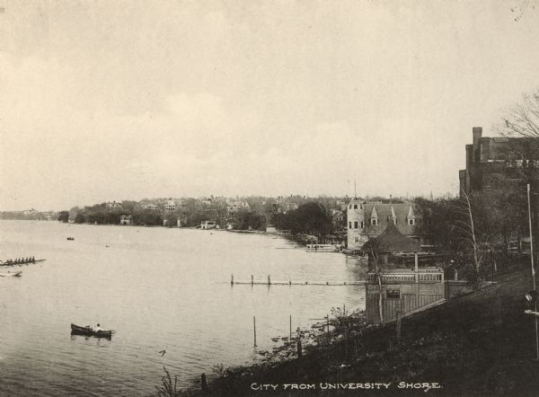 A view of the Lake Mendota shoreline, including the Armory and Gymnasium (Red Gym or Old Red) and the Old Boat House.